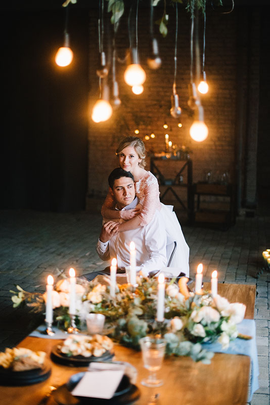 Bride and Groom with candlelit wedding centrepiece